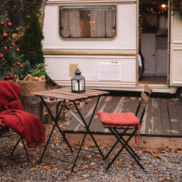 A photo of an RV park with two chairs outside