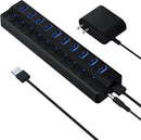 Black USB hub with multiple ports and a power adapter on a white background