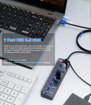 USB 3.0 hub connected to a laptop on a white surface
